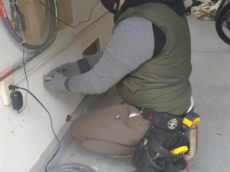 Electrician performing outlet wiring in a Laguna Hills garage